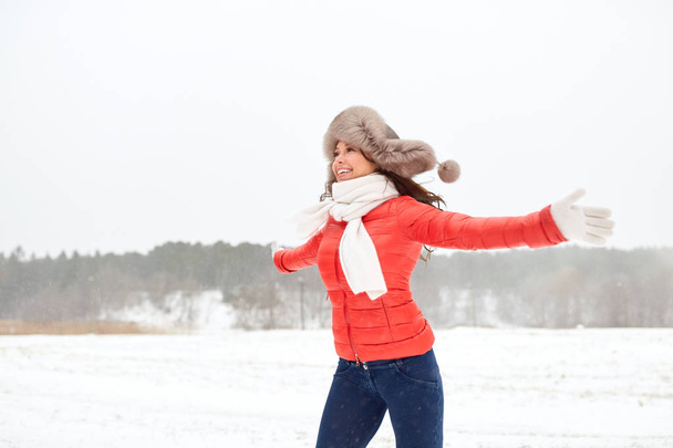 happy woman in winter fur hat having fun outdoors - Fotografie, Obrázek