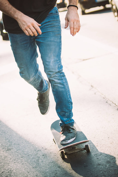 Skateboarder legs riding skateboard on the street - 写真・画像