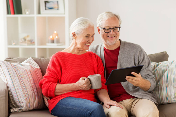 happy senior couple with tablet pc at christmas - Photo, Image