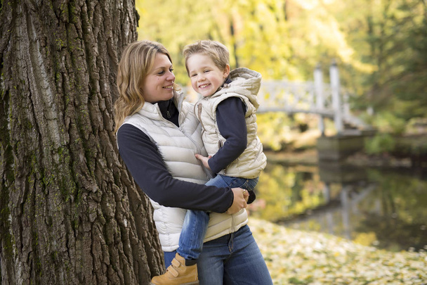 Adorable little boy with his mother in autumn park - Fotoğraf, Görsel