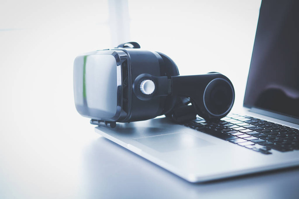Virtual reality goggles on desk with laptop. business. 3d technology - Valokuva, kuva