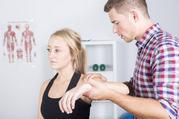 male physio therapist and woman helping patient - 写真・画像