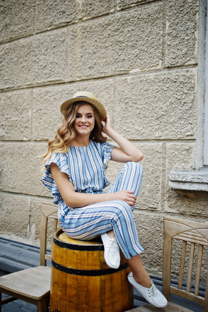 Portrait of a good-looking young woman in striped overall posing - Φωτογραφία, εικόνα