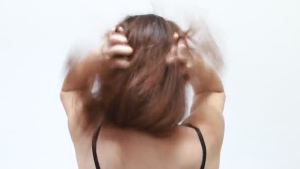 back shot of frustrated woman scratching her head violently - Кадри, відео