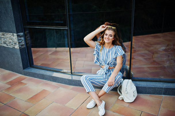 Portrait of a fabulous young woman in striped overall and sungla - 写真・画像