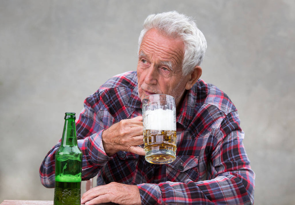 Oude man bier drinken - Foto, afbeelding