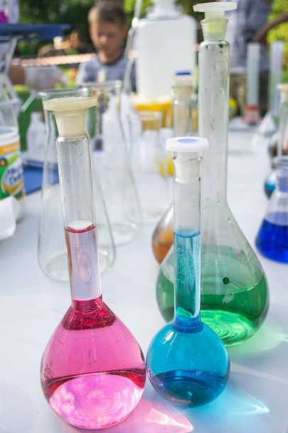 laboratory glassware with chemicals in the open air - Photo, Image