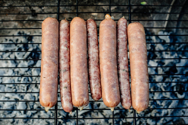 Oktoberfest. Homemade sausages are roasted on the grill. - 写真・画像