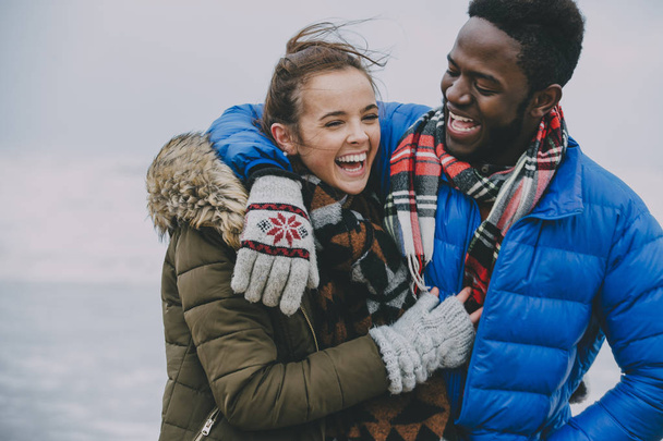 Young Couple Laughing On A Winter Beach - Foto, Imagem