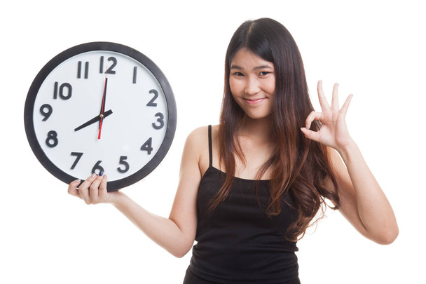 Young Asian woman show OK with a clock. - Photo, image