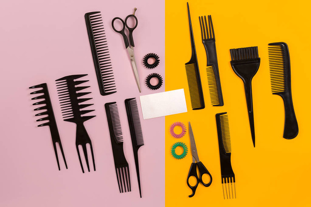 Hairdresser tools on pink and yellow background with copy space, top view, flat lay. - Fotografie, Obrázek