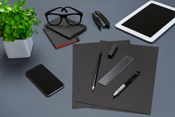 Black office stuff collection flat lay. Top view on set of stationery with smartphone and tablet - Foto, Bild