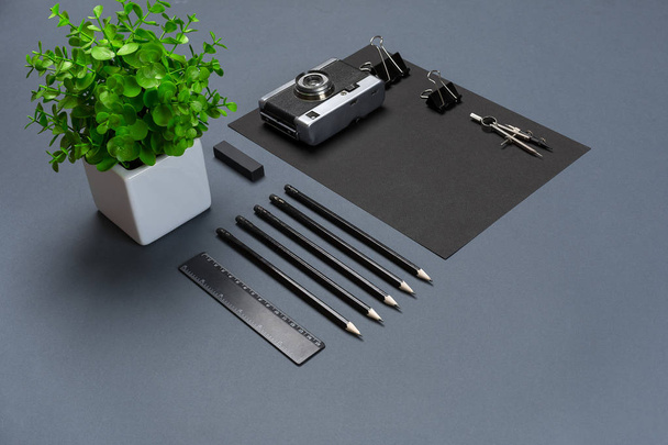 Modern mock up flat lay of blank black paper sheet and stationery on gray background. - Photo, Image