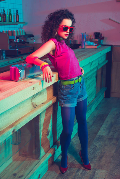 fashionable woman leaning on counter - Photo, Image
