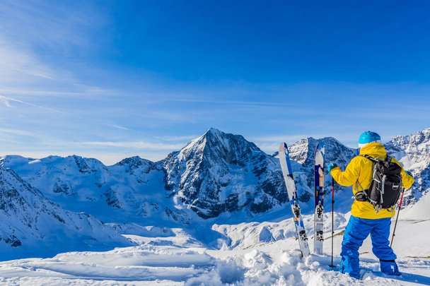 Ski alpin d'arrière-pays reposant le long d'une crête enneigée avec ski
 - Photo, image
