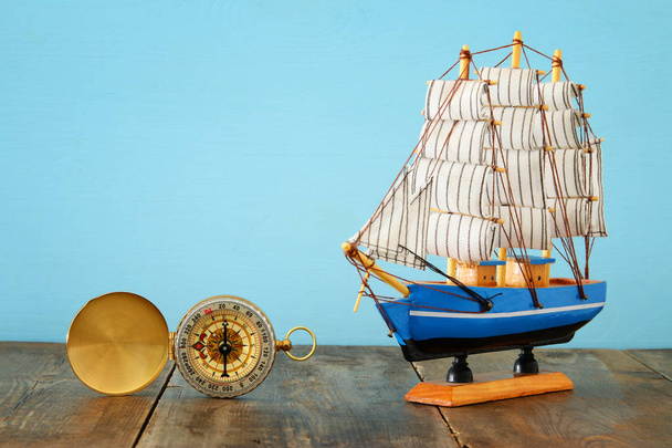Columbus day concept with old ship over wooden background - Фото, зображення