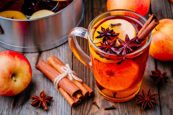 Hot mulled apple cider with cinnamon sticks, cloves and anise - Photo, Image