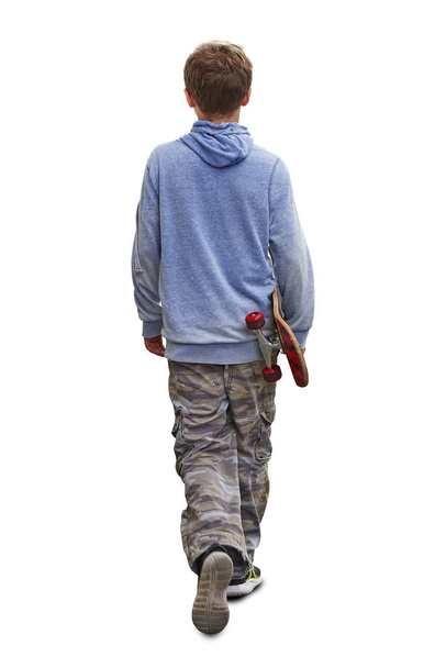 Young boy teenager walking with his skateboard isolated - Foto, Imagen