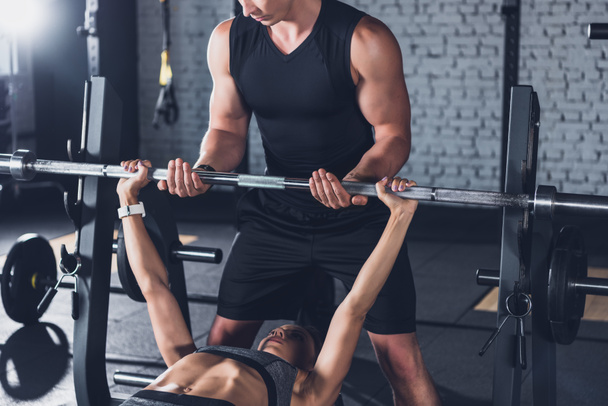 trainer helping woman weightlifting - Photo, Image