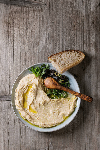 Hummus with olives and herbs - Фото, зображення