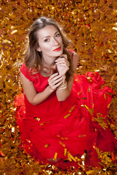 Woman sitting in red dress - Foto, Imagen