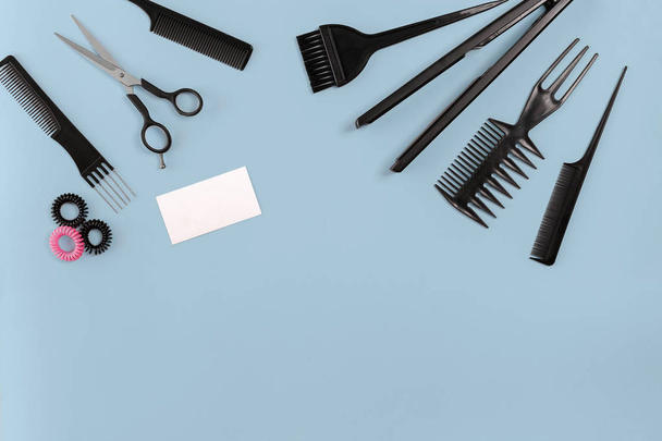 Hairdresser set with various accessories on blue background - Photo, Image