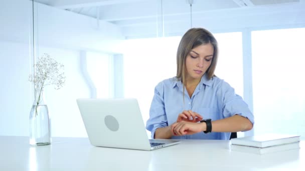 Young Woman Using Smartwatch, Sitting in Office - Video