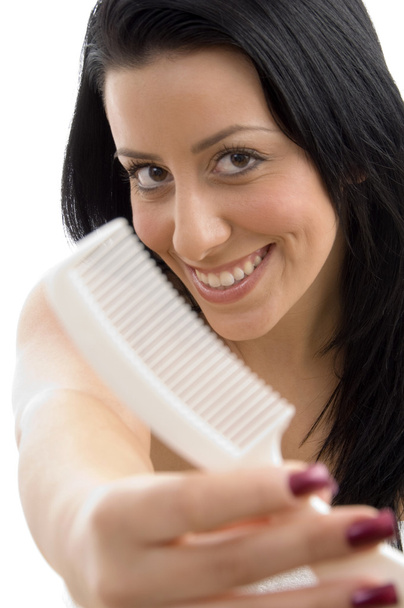Portrait of female showing comb - Foto, immagini