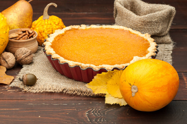 pumpkin homemade pie at wooden background arranged with food ing - Foto, afbeelding