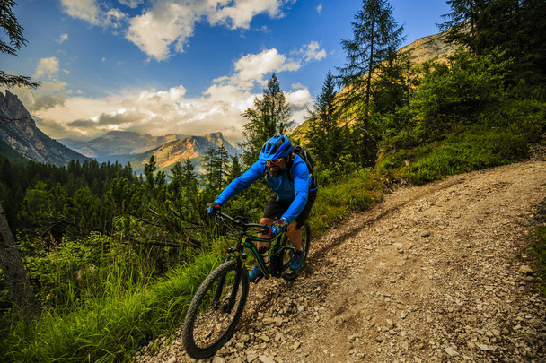 Tourist cycling in Cortina d'Ampezzo, stunning rocky mountains o - Photo, Image