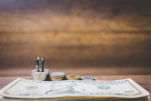 Miniature people businessman on money  - Фото, изображение