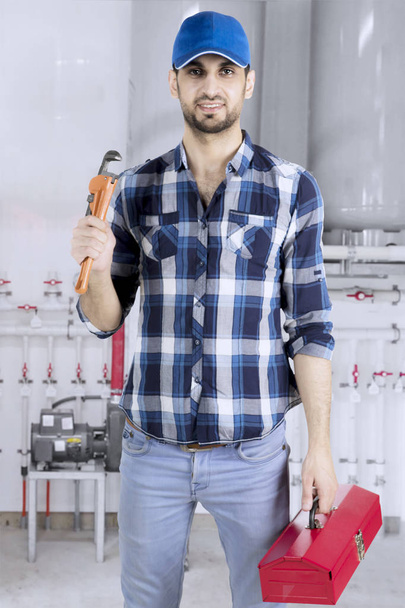 Italian plumber standing in the basement - Fotoğraf, Görsel