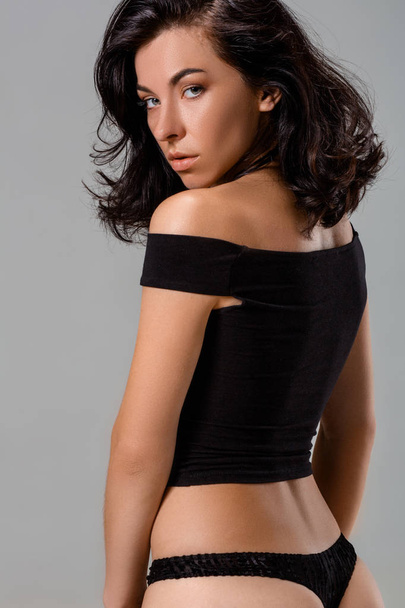Sensual brunette woman with perfect body posing in studio, looking at camera. - Foto, afbeelding