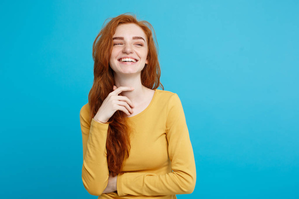 Lifestyle concept - Close up Portrait young beautiful attractive ginger red hair girl playing with her hair with shyness. Blue Pastel Background. Copy space. - Photo, Image