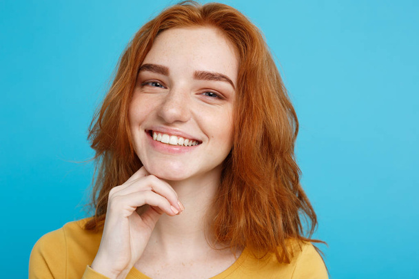 Close up Portrait young beautiful attractive redhair girl smiling looking at camera. Blue Pastel Background. - Valokuva, kuva