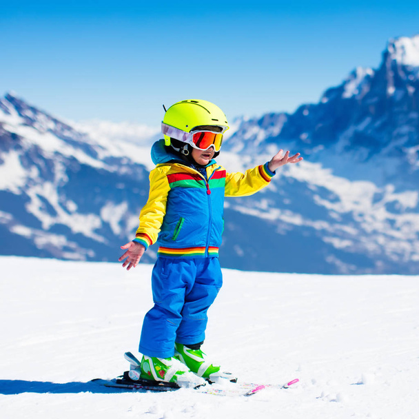 Ski and snow fun for child in winter mountains - Foto, Bild