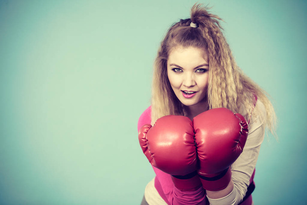 Funny girl in red gloves playing sports boxing - Фото, зображення
