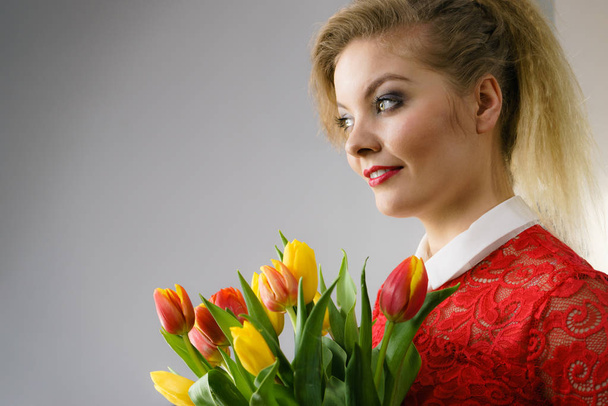 Woman holding bouquet of tulips flowers - Photo, Image