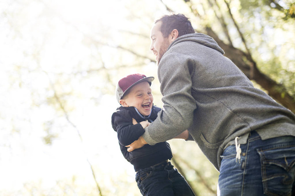 Father and son in forest on a meadow - Fotoğraf, Görsel