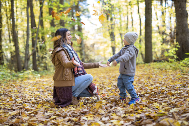 Mother with son in forest in autumn - Foto, Imagem