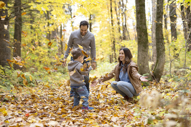 Happy family relaxing outdoors In autumn park - 写真・画像