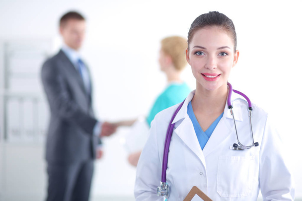 Woman doctor standing with folder at hospital. Woman doctor - Photo, image