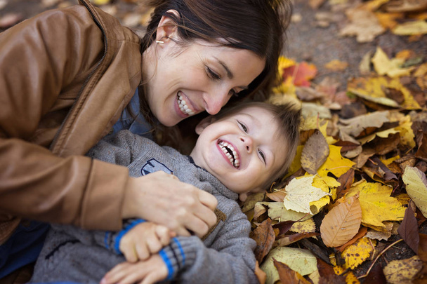 Mother with son in forest in autumn - Photo, image