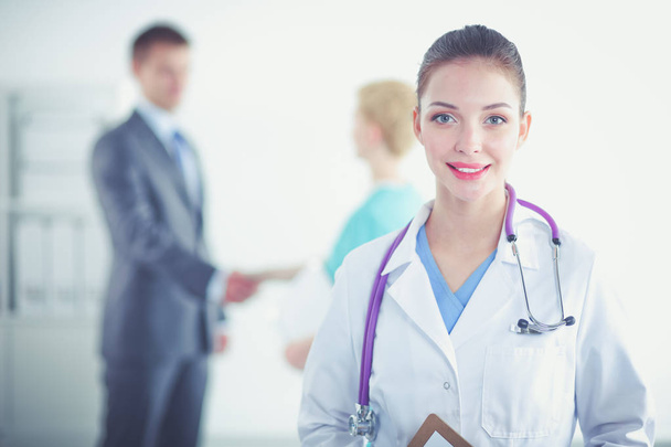 Woman doctor standing with folder at hospital. Woman doctor - Foto, afbeelding