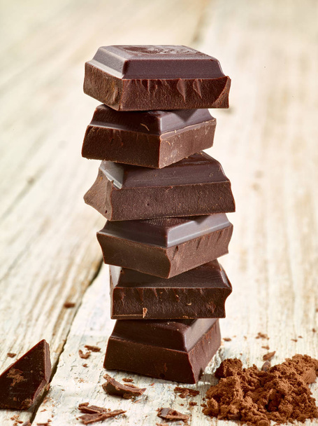 крупный план шоколадных кусочков на деревянном фоне - Фото, изображение