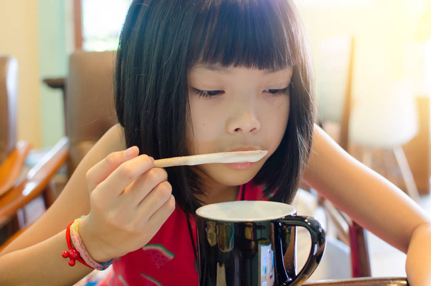 children eat milk playing phone - Photo, Image