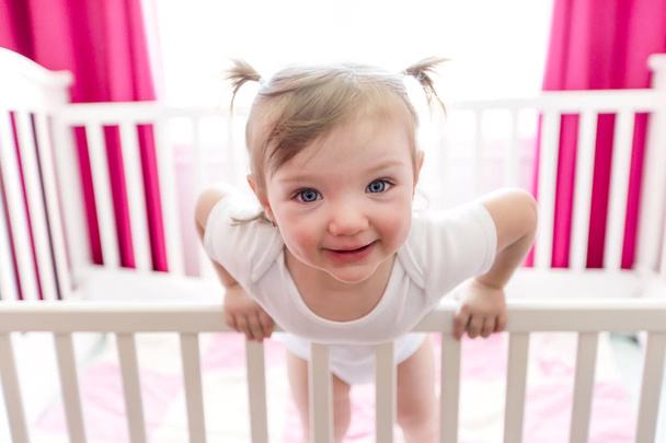 Cute little girl in cradle at baby room - Foto, Bild
