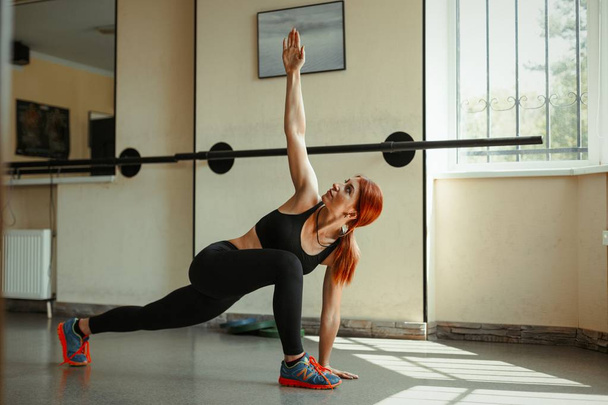 woman practicing yoga in gym - Фото, изображение