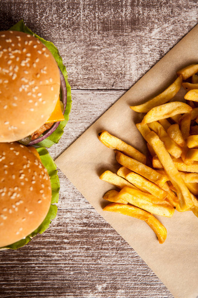 Delicious tasty burgers on wooden background - Фото, зображення