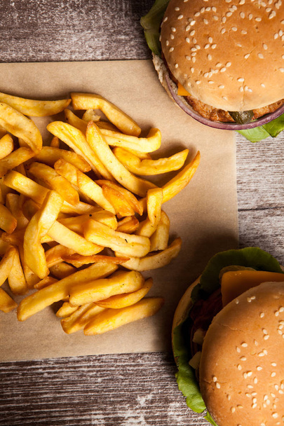 Delicious tasty burgers on wooden background - Φωτογραφία, εικόνα